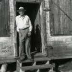 Tommy Howard, postmaster for 40 years, standing in the doorway of the post office when it was in the old store. He was born in 1877